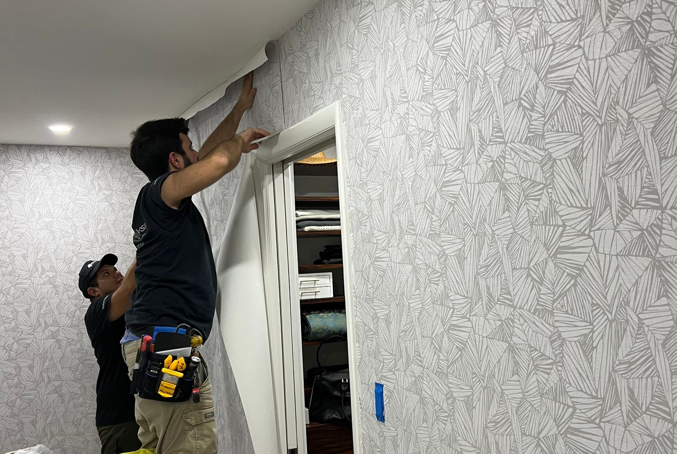 Professional wallpaper installation in progress